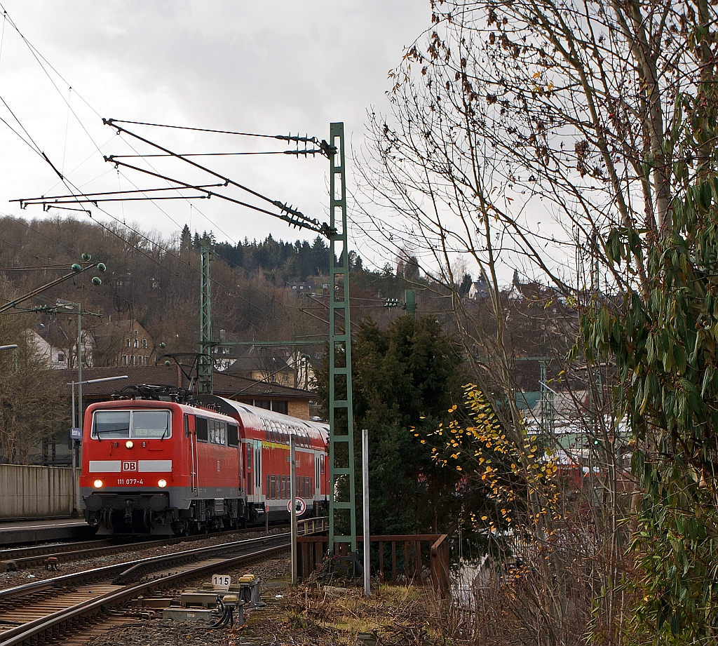 111 077-4 mit RE 9 (Rhein-Sieg-Express) Aachen - Kln - Siegen, hat hier am 10.12.2011 den Bahnhof Betzdorf/Sieg verlassen und fhrt weiter in Richtung Siegen.