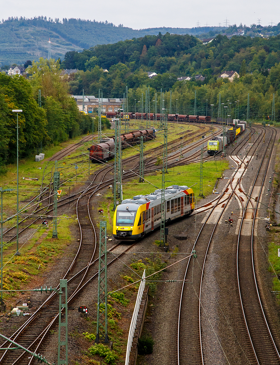 Blick auf den Rangierbahnhof (Rbf) Betzdorf/Sieg (von der Brücke in Betzdorf-Bruche)........
Der VT 263 (95 80 0648 163-3 D-HEB / 95 80 0648 663-2 D-HEB) ein Alstom Coradia LINT 41 der HLB (Hessische Landesbahn), rangiert ungewöhnlich am 20.09.2021im Rbf Betzdorf (Sieg). Im Bereich der Abstellgruppe des Rbf Betzdorf (Sieg) finden z.Z. Bauarbeiten statt.

Hinten hat die α 185 603-8 (91 80 6185 603-8 D-ATLU) einen leeren Güterzug abgestellt. 

Rechts sieht man das zweigleisige Hauptgleis der Siegstrecke.