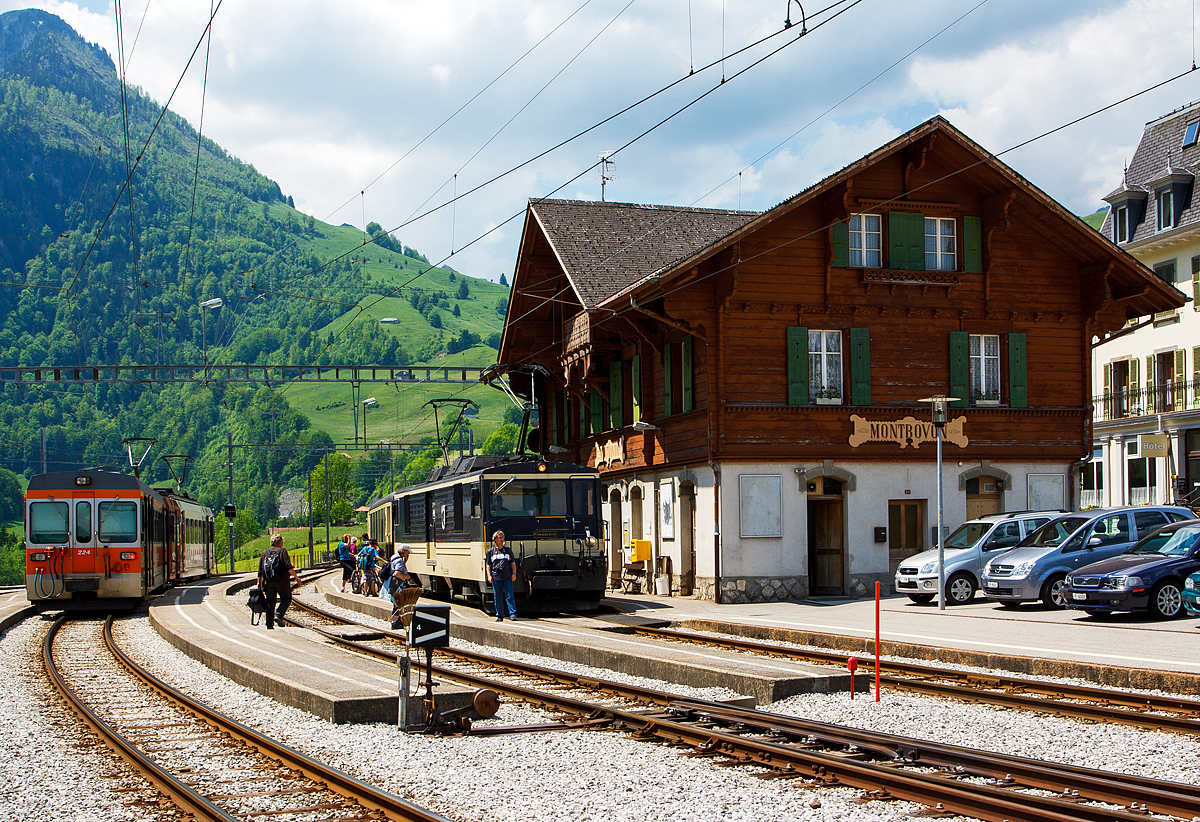 Der Bahnhof Montbovon am 28.05.2012: 
Links ein Triebzug der tpf (Transports publics fribourgeois) bestehend aus dem Bt 224 und dem Be 4/4 122. Rechts die MOB GDe 4/4 6004  Interlaken  mit einem Zug.