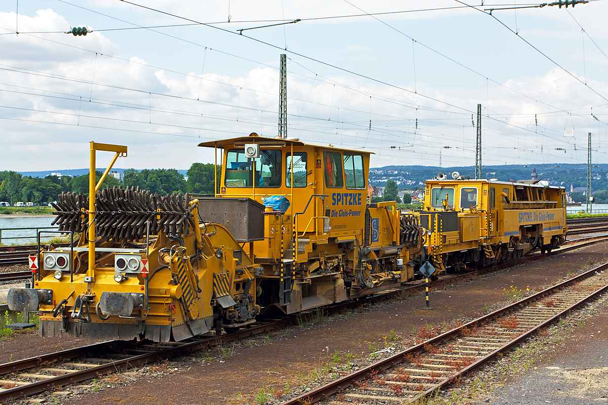 
Deutsche Plasser Schnellschotterplaniermaschine SSP 110 SW (Schweres Nebenfahrzeug Nr. D-SPAG 99 80 9425 020-1) sowie dahinter Plasser und Theurer Zweischwellenstopfmaschine (Nivellier-, Hebe-, Richt- und Stopfmaschinen) 09-32 CSM (Schweres Nebenfahrzeug Nr. D-SPAG 99 80 9222 001-6) der Spitzke SE (Großbeeren) abgestellt am 14.06.2014 in Koblenz-Ehrenbreitstein.

Die Schotterverteil- und Planiermaschinen SSP 110 SW stellen den erforderlichen Regelbettungsquerschnitt in Gleisen und Weichen her. Die Maschinen verfüllen, planieren und kehren das Gleis. Sie verfügen über Besenwellen für alle Oberbauformen und ein Silo zur Aufnahme von Schotter.
Der Schotterpflug SSP 110 SW wurde 1993 unter der Fabriknummer 484 bei der Deutsche Plasser gebaut.

Die Zweischwellenstopfmaschinen 09-32 CSM sind kontinuierlich arbeitende Stopf,- Hebe- und Richtmaschinen. Der kontinuierliche Arbeitsablauf ermöglicht sehr hohe Schichtleistungen. 
Das Stopfen im Bereich von Weichen ist mit ihr nicht möglich.
Die Maschine wurde 1995 unter der Fabriknummer 2722 von Plasser und Theurer gebaut.