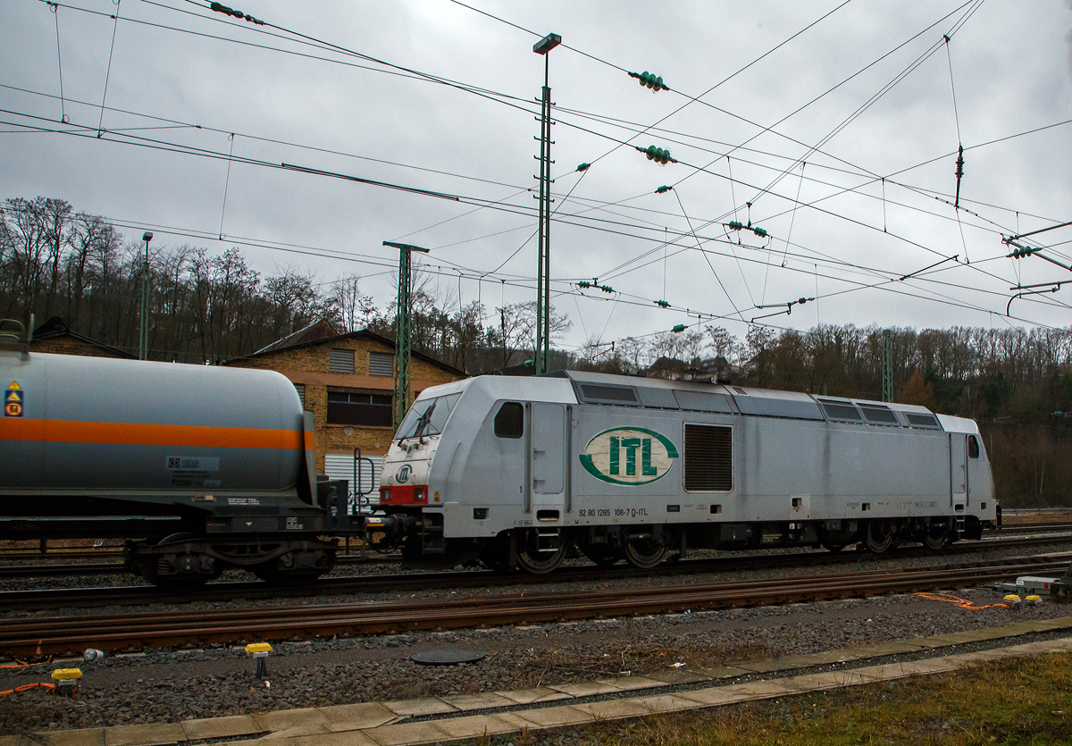 Die an die ITL Eisenbahngesellschaft mbH vermietete AKIEM 285 108-7 (92 80 1285 108-7 D-ITL) dieselt am 05.01.2022 mit einem Kesselwagenzug durch Betzdorf (Sieg) in Richtung Köln. Der Sound war ein Genuss für meine Ohren.  

Die TRAXX F140 DE wurde 2008 von der Bombardier Transportation GmbH in Kassel unter der Fabriknummer 34379 gebaut und CBRail geliefert. Ab 2013 Macquarie European Rail Ltd und 2020 hat AKIEM das Leasinggeschäft der Macquarie European Rail übernommen. Die Listen im Netz führen sie, weil AKIEM der Eigentümer ist, als 92 80 1285 108-7 D-AKIEM, aber angeschrieben ist nach meiner Sichtung „D- ITL“. Zugelassen ist diese Lok nur in Deutschland, dies liegt aber an der ausgeführten Variante (bzw. Zugsicherung).

Der Mieter ITL Eisenbahngesellschaft mbH wurde 1998 unter dem Namen „Import, Transport, Logistik“ (ITL) als Familienunternehmen gegründet. Im April 2008 kaufte die SNCF 75 Prozent der Gesellschaftsanteile. Seit 1. Dezember 2010 gehört die ITL vollständig zu SNCF Geodis, der Transport- und Logistiksparte der französischen Staatsbahn und ist in die deutsche Captrain-Gruppe integriert.

Die Lokomotiven TRAXX F140 DE sind die aus der Plattform Traxx 2e des Herstellers Bombardier hervorgegangene Mehrzweck-Dieselversion. Sie sind mit einem 2.200 kW (3.000 PS) starken MTU 16V 4000 R41L Dieselmotor und elektrischer Wechselstrom-Kraftübertragung ausgestattet, so dass sie eine Anfahrzugkraft von 270 kN und eine maximale Betriebsgeschwindigkeit von 140 km/h erreicht. Diese Lokomotiven sind beliebt bei Unternehmern, die elektrische Traxx-Flotten im Betrieb haben, aber für Strecken mit langen, nicht elektrifizierten Abschnitten zuverlässige Zugkraft brauchen.

TECHNISCHE DATEN der BR 285 (TRAXX F140 DE):
Hersteller: Bombardier Transportation
Baujahre: 2007 bis 2013 (35 Stück)
Spurweite: 1.435 mm
Profil: UIC 505-1
Achsfolge: Bo´Bo´
Länge über Puffer: 18.900 mm
Drehzapfenabstand: 10.440 mm (virtuell)
Achsabstand im Drehgestell: 2.600 mm
Treibraddurchmesser: 1.250 mm (neu) / 1.170 mm (abgenutzt)
Breite: 2.977 mm
Höhe: 4.264 mm
Dienstgewicht: 82 t
Maximale Geschwindigkeit: 140 km/h
Anfahrzugkraft: 270 kN
Dauerzugkraft: 240 kN ab 26 km/h

Dieselmotor Hersteller: Motoren- und Turbinen-Union, Friedrichshafen (MTU)
Dieselmotor Art/Typ: wassergekühlter V-16-Zylinder- 4Takt-Dieselmotor mit zweistufiger Turboaufladung und Ladeluftkühlung, sowie mit Common-Rail-Einspritzsystem vom Typ  MTU 16V 4000 R41L
Der Motor schaltet im Leerlauf  8 der 16 Zylinder ab, um den Spritverbrauch und Schadstoffausstoß zu senken.
Motor-Hubraum : 76,265 l (Bohrung 170 mm, Hub 210 mm)
Motorgewicht: 7.930 kg (trocken) / 8.510 kg (nass)
Dieselmotorleistung: 2.200 kW (3.000 PS) bei 1.800 U/min

Kraftübertragung: dieselelektrisch
Traktionsmotoren:  4 Stück Drehstrom-Asynchronmotor
Leistung am Rad: 1.825 kW
Antrieb: Tatzlagerantrieb
Bremskraft: 150 kN
Elektrische Bremsleistung: max. 1.000 kW
Tankvolumen: 5.000 l 
Bauart der Bremsen: Druckluftbremse, Feststellbremse, Dynamische Bremse
Kleister befahrbarer Gleisbogen: R = 100 m
Zugsicherung: GSM-R, PZB90 
Bremsgewicht: P 90 G 77