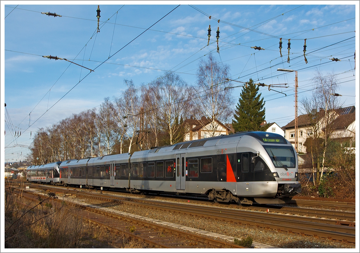 
ET 22008 der Abellio Rail NRW GmbH ein kurzer FLIRT (2-teiliger Stadler Flirt EMU 2 bzw. BR 0426.1) mit Werbung  150 Jahre Ruhr-Sieg-Strecke  gekuppelte mit ET 23008 (3-teiliger Stadler Flirt EMU 3 bzw. BR 0427), als RE 16  Ruhr-Sieg-Express  (Siegen-Hagen-Essen), am 19.01.2014 kurz vor dem Bahnhof Kreuztal.