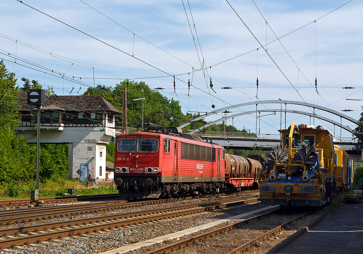 Links die abgestellten Schnellschotterplaniermaschine SSP 110 SW und die Plasser und Theurer Universalstopfmaschine Unimat 09-475/4S versperren etwas die Sicht.....
Die 155 114-2 der DB Schenker Rail Deutschland AG, ex DR 250 114-6, ist am 18.07.2014 in Kreuztal mit einem schweren gemischten Güterzug in Richtung Hagen losgefahren.

Der Güterzug wurde von der 140 600-8 nachgeschoben (bis Welschen Ennest). Ein Bild davon gibt es unter: http://hellertal.startbilder.de/bild/deutschland~strecken~kbs-440-ruhr-sieg-strecke/354229/die-140-600-8-der-db-schenker.html

Der Stromcontainer wurde 1980 bei LEW (VEB Lokomotivbau Elektrotechnische Werke Hans Beimler) in Hennigsdorf unter der Fabriknummer 16705 gebaut und als 250 114-6 an die DR (Deutsche Reichsbahn) geliefert, 1992 umgezeichnet in DR 155 114-2 und 1994 in DB 155 114-2

Seit 2007 hat sie die NVR-Nummer  1 80 6155 114-2 D-DB.

(BB-Bild ohne OL-Mast im rechten Bildrand)