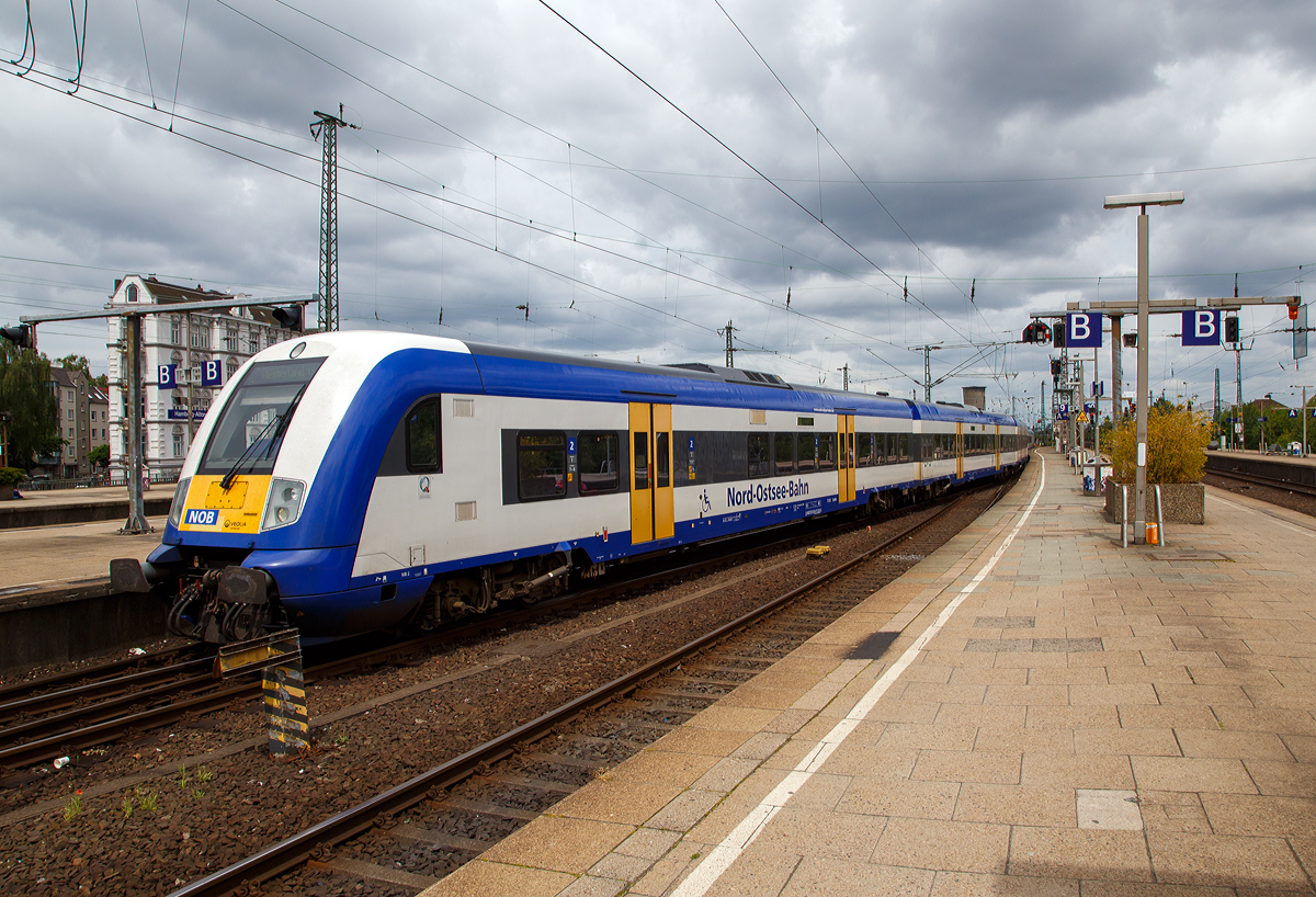 Steuerwagen voraus fährt am 16.06.2015 der Zug der NOB (Nord-Ostsee-Bahn GmbH) von Westerland auf Sylt in den Zielbahnhof Hamburg-Altona ein. 

Der Zug besteht aus Reisezugwagen vom Typ Bombardier Married Pairs, geschoben von der Siemens ER20 - DE2000-02 (223 054-8).

Der Bombardier Married Pair Steuerwagen ist der (75 102) Bpmbdfa D-NOB 55 80 80-75 002-8. Der Steuerwagen verfügt über zwei Endgroßräume mit Sitzbereichen der 2. Klasse sowie über ein Mehrzweckabteil mit Klappsitzen im mittleren Großraum. Der Steuerwagen ist behindertengerecht ausgeführt, die behindertengerechte Ausstattung umfasst einen Hublift und ein barrierefreies WC.

Die Bombardier Married Pairs sind einstöckige Reisezugwagen des Herstellers Bombardier, die auf der Marschbahn eingesetzt werden. Zwei Wagen sind jeweils zu einer nur in der Werkstatt trennbaren Einheit verbunden.

Mögliche Wagenreihungen:
Aus den vorhandenen Fahrzeugen kann als kleinste betriebsfähige Einheit eine 4-teilige Wagengarnitur aus je einem End- und Steuerwagen sowie zwei Mittelwagen mit Energieversorgungsanlage gebildet werden. Darüber hinaus können bis zu 3 Paare aus je einem Mittelwagen mit und einem Mittelwagen ohne Energieversorgung eingereiht werden. In der Regel wurden bei der NOB 4- und 6-Wagen-Züge gebildet. 

TECHNISCHE DATEN des Steuerwagens: 
Baujahr: 2005
Spurweite: 1.435 mm
Länge über Puffer:  27.300 mm
Wagenkastenbreite:  2.764 mm
Drehzapfenabstand: 19.000 mm
Achsstand im Drehgestell:  2.500 mm
Leergewicht:  42 t
Höchstgeschwindigkeit:  160 km/h
Bremsbauart: KE-PR-A-mZ (D) [NBÜ2004]
Sitzplätze:  78 in der 2. Klasse
Abteile: 2 Großräume 2. Klasse, 1 Mehrzweckraum 
Fußbodenhöhe:  760 mm
Niederfluranteil:  100 %
Kupplungstyp: Schraubenkupplungen (vorne), Schalenmuffenkupplung (zum Mittelwagen)

Zum Fahrplanwechsel 2016 musste die Nord-Ostsee-Bahn ihre letzte Strecke (die Leistung der Marschbahn) an die DB Regio Schleswig-Holstein abgeben.