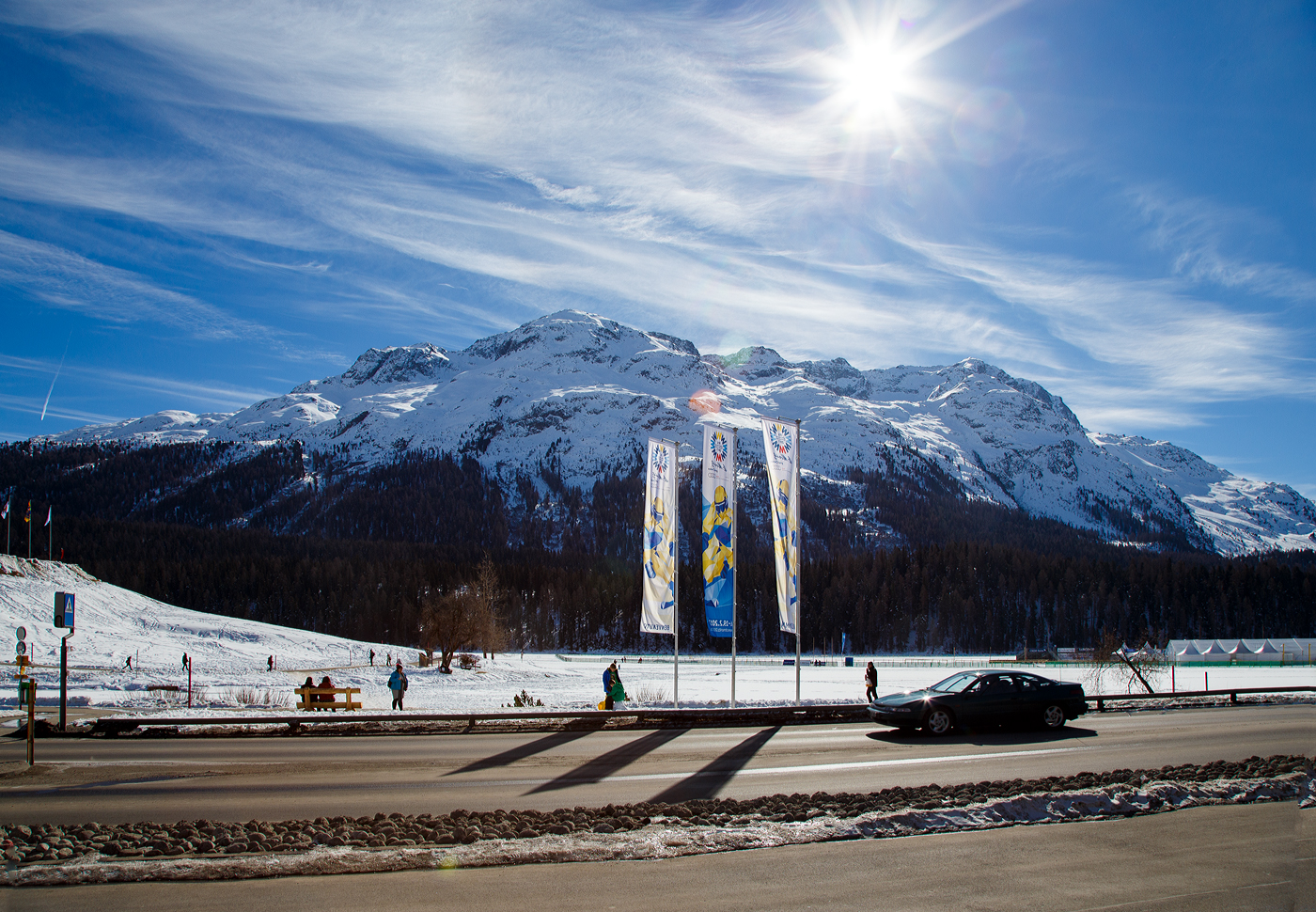 Blick vom RhB Bahnhof Sankt Moritz (San Murezzan) im Oberengadin über den St. Moritzersee auf die Engadiner Berge in südlicher Richtung auf die Engadiner Berge (höchste davon ist der 4.048 m hohe Piz Bernina) am 20 Februar 2017. 

Die Fahnen zeigen es noch bis eine Tag zuvor, vom 6. bis 19. Februar 2017, fanden in St. Moritz die 44. Alpinen Skiweltmeisterschaften statt.