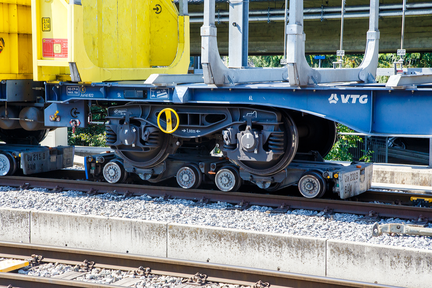 Ein normalspuriges Drehgestell des leeren 2 x vierachsiger Flachwagen in Sonderbauart (INNOFREIGHT Holz-Doppelwagen), 37 80 4657 028-9 D-VTG, der Gattung Sggmrrs S240, verladen auf zwei schmalspurige Rollböcke Ua 2xx vom Typ Vevey, am 07 September 2023 an einer Rollbockgrube beim Bahnhof Morges.

Die Rollböcke dienen zum Transport von Normalspurwagen (meist Güterwagen) auf Schmalspurgleisen (wie hier 1.000 mm). Ein Rollbock ist 1,65 t schwer und trägt jeweils eine Normalspur-Wagonachse mit einer maximalen Achslast von 22,5 t. Bei z.B. einem vierachsigen Drehgestell Wagen kommen so vier Rollböcke zum Einsatz, wobei der Wagen somit bis zu 90 t schwer sein kann.

TECHNISCHE DATEN:
Spurweite: 1.000 mm
Achsanzahl: 2
Eigengewicht: 1,65 t
Traglast: 22,5 t 

Ein Rollbock ist ein meist zweiachsiges Schienenfahrzeug (Wagen), mit dem ein andersspuriges Eisenbahnfahrzeug auf der Spurweite des Rollbocks befördert werden kann. In Süddeutschland wird er auch als Rollschemel bezeichnet, nicht aber in der Schweiz, wo dieses Wort einen Rollwagen bezeichnet. Entwickelt wurde der Rollbock 1881 von Paul Langbein (1842–1908).

Funktion:
Durch den Einsatz von Rollböcken entfällt im Güterverkehr das Umladen der Güter in Fahrzeuge der anderen Spurweite. Das Aufbocken von Personenwagen war nicht üblich, da die Reisenden selbst relativ leicht die Fahrzeuge wechseln konnten und das Kipp-Risiko bei Personenbeförderung nicht akzeptabel war. Zu besonderen Anlässen wurden aber Spezialwagen verladen, beispielsweise Salon- oder Kinowagen. Grundsätzlich ist anzumerken, dass es, insbesondere in Deutschland, kein zusammenhängendes Schmalspurnetz, ähnlich jenem in Normalspur, gibt oder gab. Daher war eine weitgehende Normung und Standardisierung, die bei den normalspurigen Eisenbahnen die Interoperabilität sicherstellt, nicht zwingend und fand nicht statt. Folglich kam es zu zahlreichen technischen Insellösungen, auch bei den Rollböcken. Die grundsätzliche Funktion ist aber stets dieselbe. Neben technischen Unterschieden waren daraus folgend die Vorschriften für den Betrieb verschieden, wobei die Vorschriften zum Teil die Technik beeinflussten, zum Teil aber auch in der Folge der technischen Voraussetzungen erlassen wurden.

Rollböcke werden seitens der Eisenbahnindustrie im Übrigen auch dafür eingesetzt, andersspurige Fahrzeuge über Normalspur vom Hersteller zu Testeinrichtungen oder zu ihrem Einsatzgebiet zu transportieren. So setzt die RailAdventure GmbH solche Fahrzeuge – bei ihr Loco Buggys genannt – ein.

Technik
Der Rollbock ist ein schmalspuriges Fahrzeug mit sehr kurzem Achsstand (ähnlich einem Drehgestell), auf dem die Räder jeweils eines Radsatzes des Normalspurwagens verankert werden. Beladen wird der Rollbock von einer speziellen Rollbockgrube aus. Abhängig von der konkreten Ausgestaltung der Rollböcke konnten auch dreiachsige Wagen aufgebockt werden. 

Güterwagen auf Rollböcken (oder Rollwagen) können zu ganzen Güterzügen zusammengestellt werden. Je nach örtlicher Betriebsvorschrift konnten schmalspurige Personenwagen in die Züge eingereiht werden, häufig waren die Reihungsfolgen reglementiert. Zum Teil waren bzw. sind die Rollböcke mit dem jeweiligen Bremssystem (Druckluft, Saugluft) oder Heberleinbremse der Schmalspurbahn ausgerüstet, es gab aber auch ungebremste Rollböcke. Einige Bahnen stellten in diesem Fall so genannte Bremswagen in die Züge ein, die ballastiert waren, um größeres Bremsvermögen zu besitzen. Teilweise wurden die Bremsleitungen der Normalspurwagen mitverwendet und die Rollbockbremsen über T-Stücke an diese angeschlossen. Normalspurwagen auf Rollböcken werden entweder direkt miteinander gekuppelt oder die Rollböcke mittels Kuppelstangen verbunden. Bei der direkten Kupplung sind diese „lang zu machen“, das heißt, nicht straff anzuziehen, da die Puffer die Wagen in den häufig engen Radien sonst von den Rollböcken drücken würden. Die Verbindung mit dem Zugfahrzeug kann ebenfalls über Kuppelstangen erfolgen. Es gibt aber auch die Möglichkeit, so genannte Pufferwagen zu verwenden. Diese schmalspurigen Wagen besitzen Zug- und Stoßvorrichtungen, die in Ausführung und Höhe zu jenen der aufgebockten Normalspurwagen passen und somit als Adapter dienen. Es wurden auch Lokomotiven mit solchen angepassten Normalspur-Zug-und-Stoßvorrichtungen verwendet.

Rollböcke nach dem System Vevey
Um den beim System Langbein personal- und zeitaufwändigen Verladevorgang zu vereinfachen, entwickelte die schweizerische Bahngesellschaft YSteC 1974 ein neues Prinzip. Hierbei wird die Achse des Normalspurwagens nicht mehr fixiert. Der Wagen steht mit seinen Rädern in speziell geformten Mulden. Derartige Rollböcke, als System „Vevey“ von den Ateliers de constructions mécaniques de Vevey (ACMV) in Serie gefertigt, werden bei mehreren Bahnen in der Schweiz und einer Bahn in Deutschland (HSB) eingesetzt. Der Hauptunterschied zum klassischen Rollbock ist, dass das Aufbocken bei langsamer Fahrt automatisch geschieht. Somit sind zahlreiche Unannehmlichkeiten und Gefährdungspotenziale behoben, weswegen beispielsweise die Harzer Schmalspurbahnen ihre Rollwagen durch solcherlei Rollböcke ersetzt haben, ähnlich wie zuvor diverse Schweizer Bahnen.

Die mögliche Rationalisierung konnte aber nicht verhindern, dass der Güterverkehr auf zahlreichen Schmalspurbahnen dennoch eingestellt wurde. Rollbockanlagen im kommerziellen Betrieb gibt es nur noch in Nordhausen, Langenthal, Morges und Yverdon, die Anlage in Worblaufen dient noch Diensttransporten. In Interlaken Ost wurde 2021 eine neue Rollbockanlage erstellt.